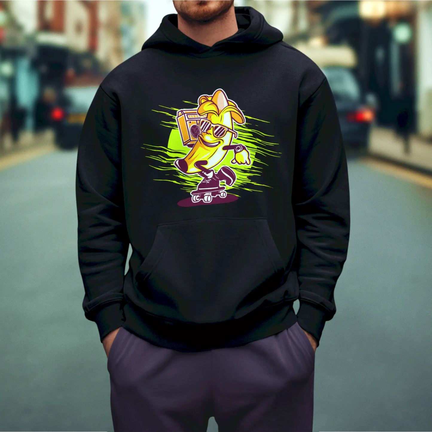 A quirky banana on a pink scooter pops off the black hoodie with bold, humorous style - Μια ιδιόρρυθμη μπανάνα σε πατίνι ξεχωρίζει πάνω στο μαύρο hoodie με έντονο, χιουμοριστικό στυλ_result