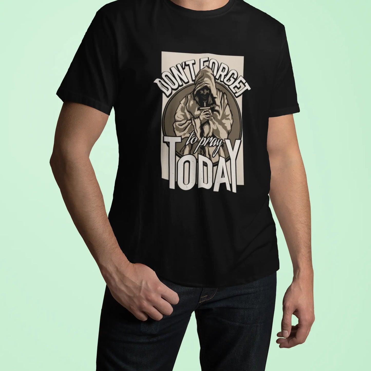 Black cotton top highlighting the detailed t-shirt print of a praying figure. — Μαύρο βαμβακερό μπλουζάκι που αναδεικνύει το λεπτομερές τύπωμα μιας φιγούρας που προσεύχεται