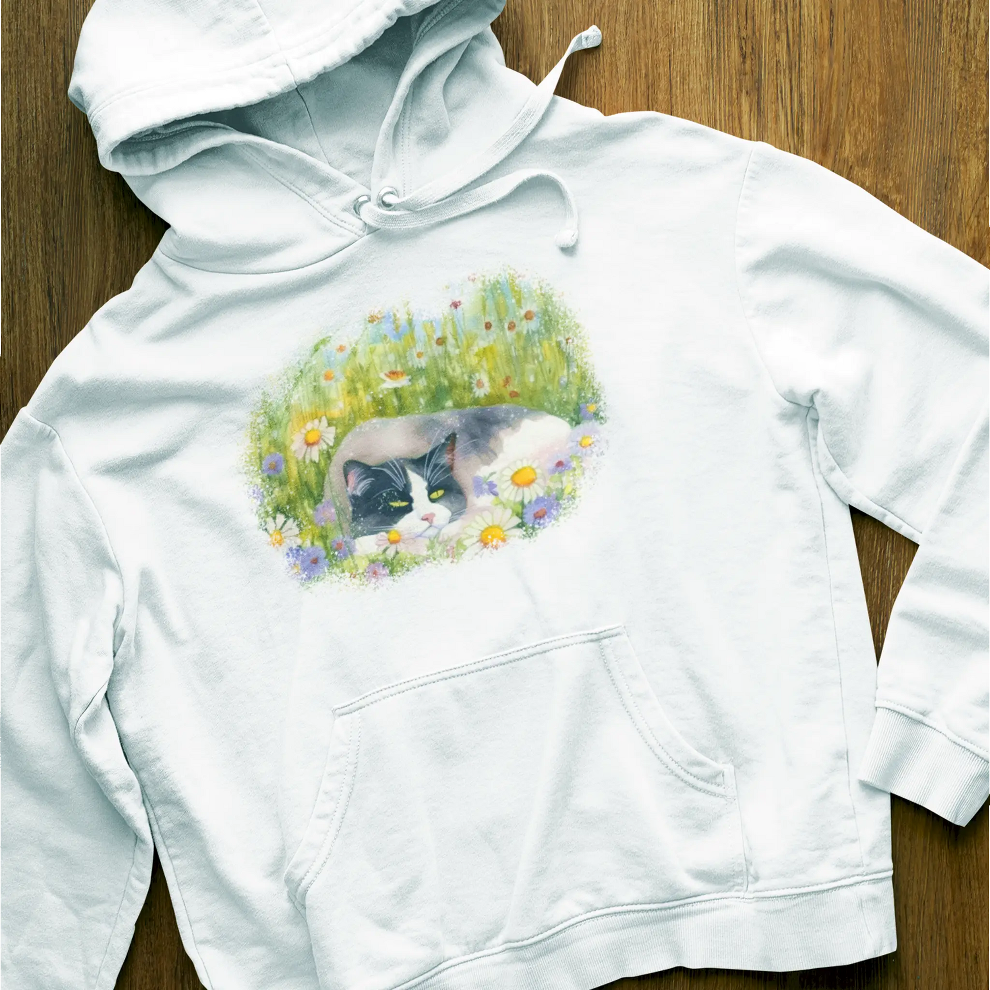 Comfortable white hoodie showcasing serene cat portrait nestled in blooming meadow watercolor artwork - Άνετο λευκό hoodie με γαλήνιο πορτρέτο γάτας φωλιασμένο σε ανθισμένο watercolor λιβάδι