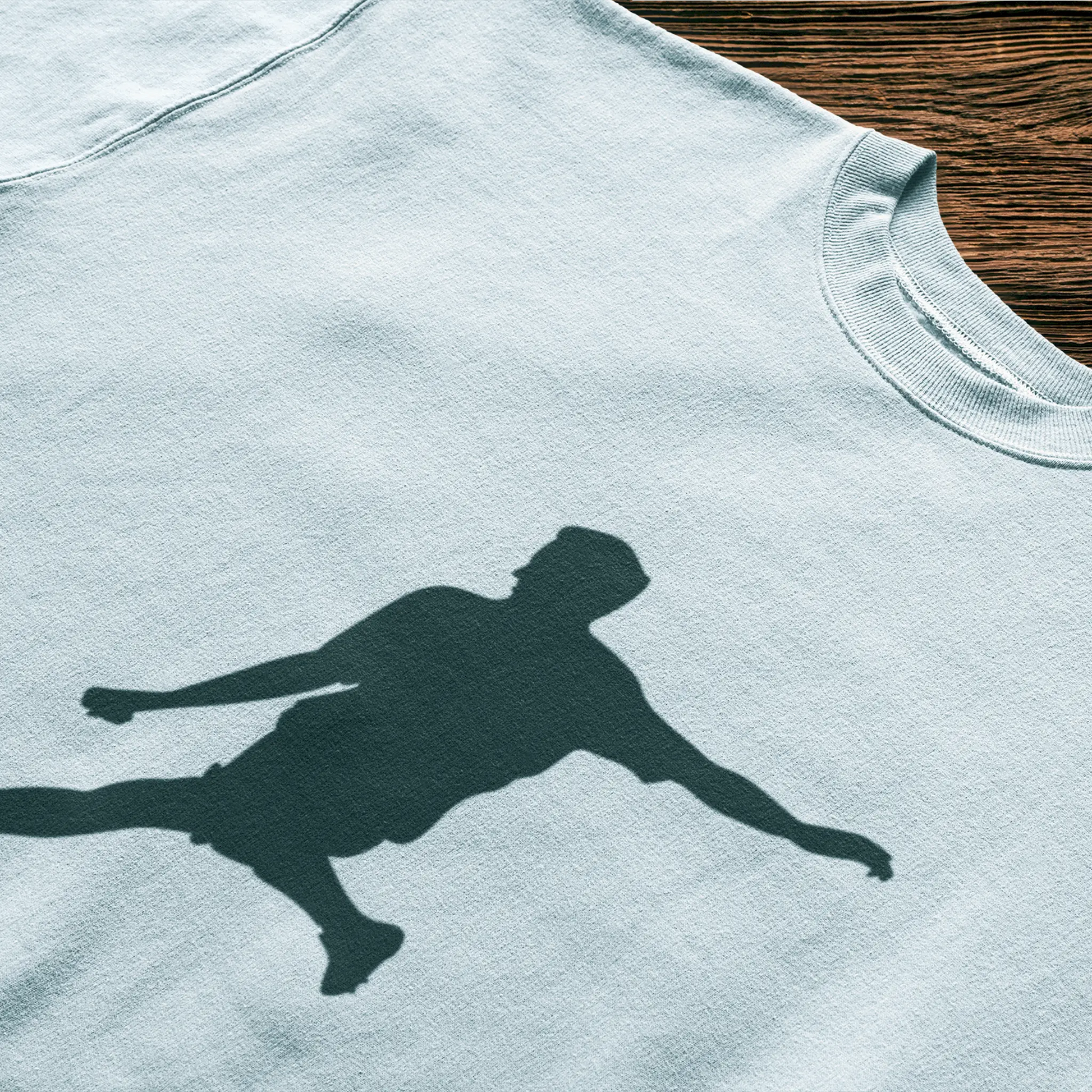 Football silhouette on white t-shirt and athletic movement - λευκό αθλητικό μπλουζάκι με ποδοσφαιριστή σε δυναμική κίνηση