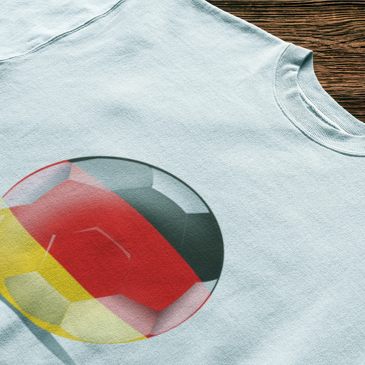 Germany’s iconic colors wrapped around a football on a white t-shirt – clean and proud. Τα εμβληματικά χρώματα της Γερμανίας αγκαλιάζουν μια μπάλα ποδοσφαίρου σε λευκό t-shirt – καθαρό και περήφανο