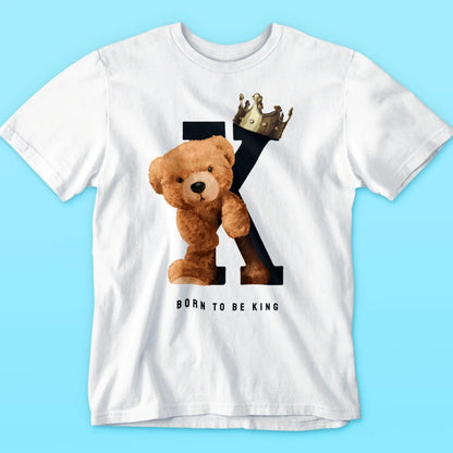 Minimal white tee with teddy leaning on K and wearing royalty crown – Μινιμαλιστικό λευκό t-shirt με αρκούδο που ακουμπά το K και φορά βασιλική κορώνα