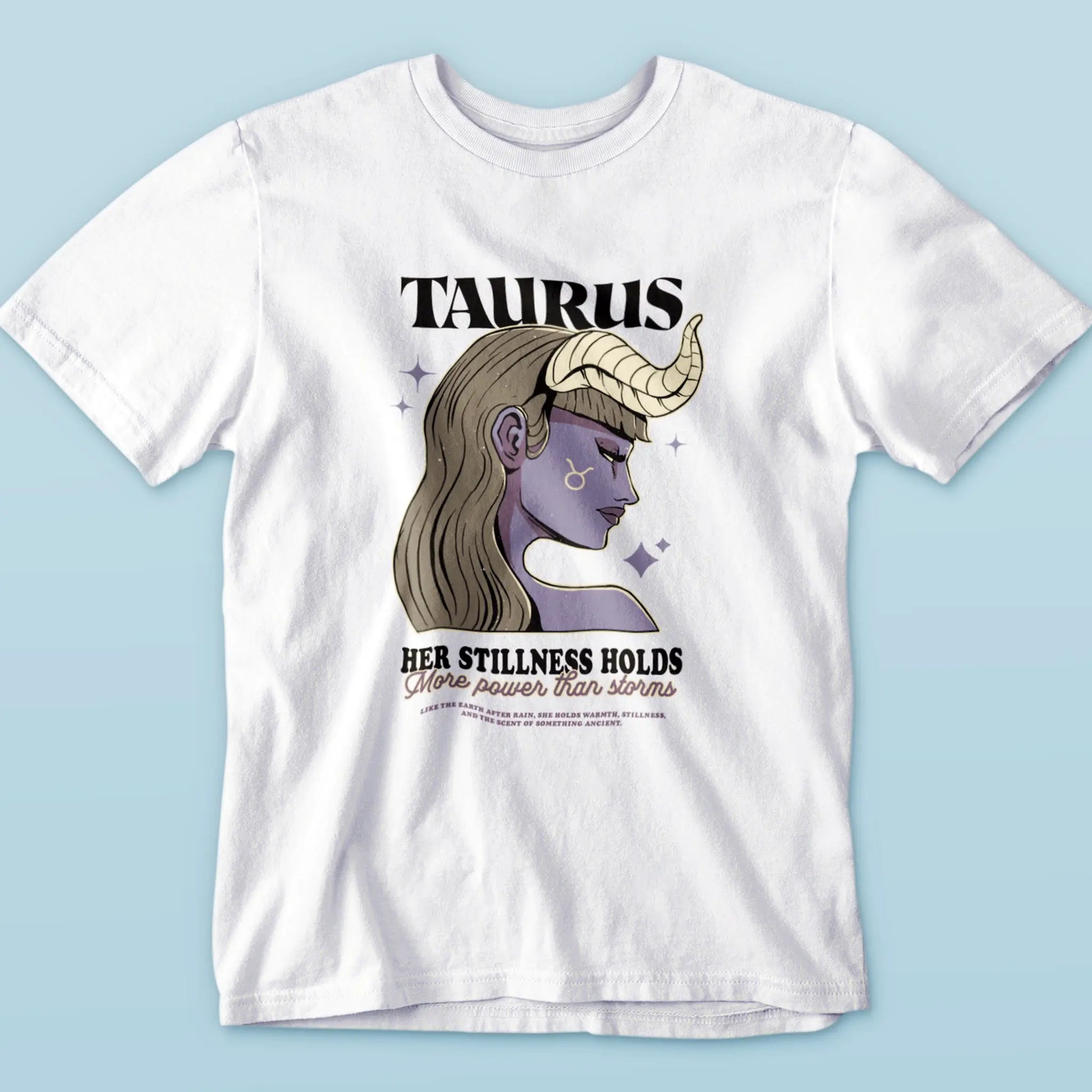White tee showcasing Taurus woman illustration with soft details, stars, and serene energy – Λευκή μπλούζα με απεικόνιση Ταυρίνας, αστέρια και αύρα γαλήνης.
